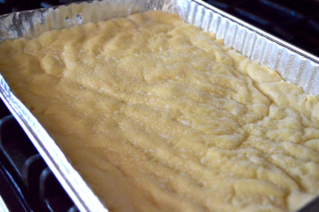 I pressed half of the dough out into my well greased 9 x 13 pan to form the bottom crust. It needed to bake for 15 minutes to get golden and glorious! 