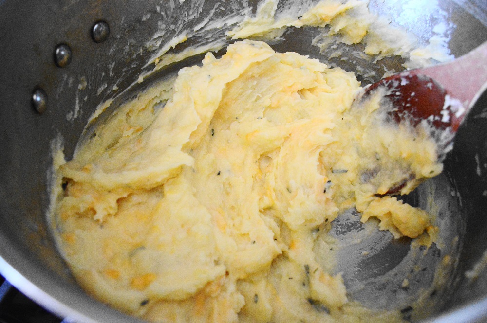 I started the potatoes first since they needed to boil for about 25-30 minutes. I wanted them super tender and mashable. Once they were cooked enough, I stirred in lots of butter, garlic, rosemary and cheddar. I let them cool a minute before adding an egg yolk. Oh my goodness, the egg yolk made them so rich! These were the perfect fluffy potatoes to top the shepherd's pie. 