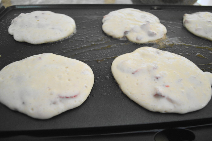 The strawberry lemon ricotta pancakes cooking away on the griddle.