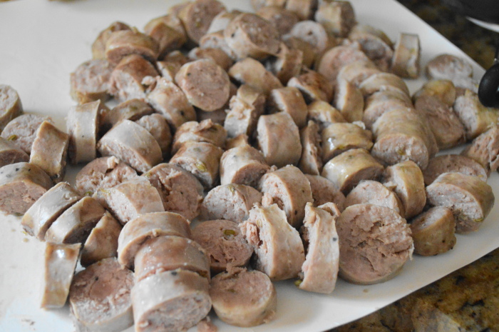 The sausage links cooked and cooled, then cut into thin rounds. 