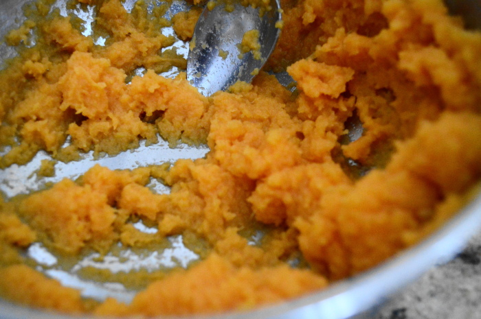 The wet ingredients for the spiced sweet potato bundt cake stirred together into what is basically mashed sweet potatoes. 