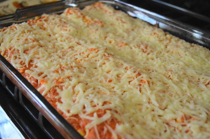 The tray of shrimp scampi lasagna rolls all bubbly just out of the oven. 
