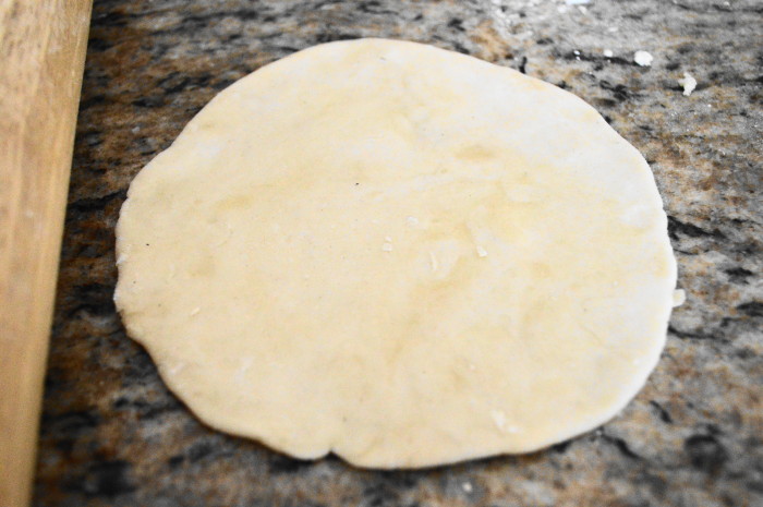 Then I rolled each one out into a taco shell sized circle about 1/4 of an inch thick. I happen to have a tortilla press because I'm a sucker for kitchen gadgets. After pressing, they just needed a little more rolling out to get the homemade tortillas to the desired size. A rolling pin could have done the whole job though!