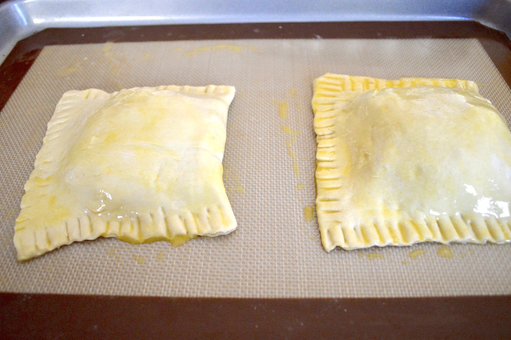 Then I brought the other sides of the sheets over and crimped the edges together tightly. A fork made the edge prettier and more finished looking. To finish them I brushed a lightly beaten egg all over, especially around the edges. That was all there was to forming the Thanksgiving leftover turnovers! I baked them at 350 for 20 minutes to get them golden and glorious.