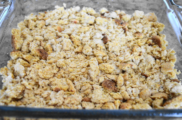 While the sausage cooled, I crumbled up my biscuits right into my greased 8 x 8 pan. They were day old biscuits, so they were absolutely perfect for crumbling. I pressed down to make them into an even layer. 