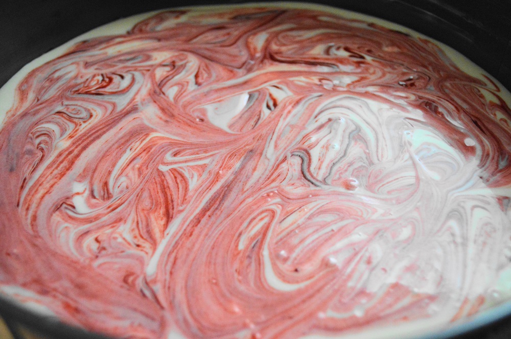 I used a springform pan for this operation so that it would be easy to release the red velvet cheesecake hearts. The brownie batter went in first, but I reserved about 1/4 cup of it. That remaining batter was swirled in with the cheesecake batter on top. It looked so pretty! 