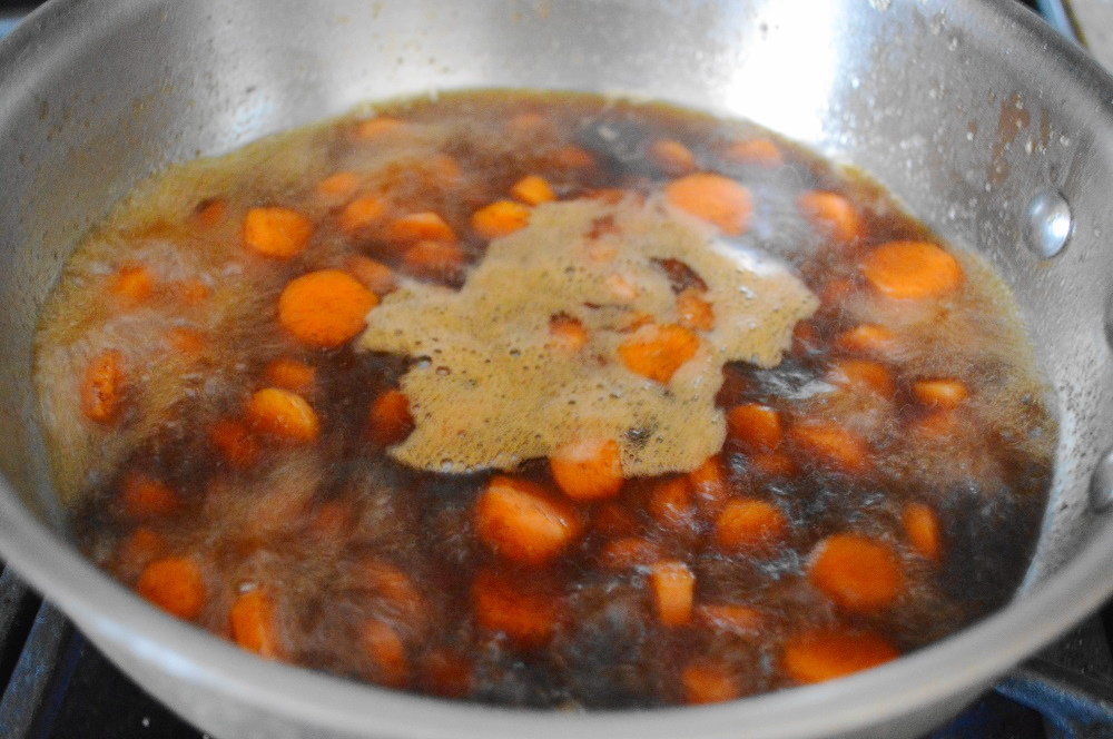 Those carrot rounds were gently boiled in an incredibly flavorful mixture. It was a combination of chicken stock (veggie stock would have worked too), bourbon whiskey, brown sugar, cinnamon and salt. I let all of that reduce completely to become a syrupy glaze that lovingly coated the carrots. 