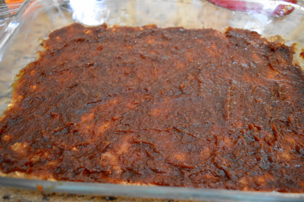 I pressed half of the dough out into my greased 9 x 13 pan to be a thin bottom layer. Then that poor, lonely jar of fig jam was spread out in a thin layer on top of the bottom layer. The rest of the dough was sprinkled evenly on top of the fig jam. That was all there was to assembling these amazing oatmeal fig bars!