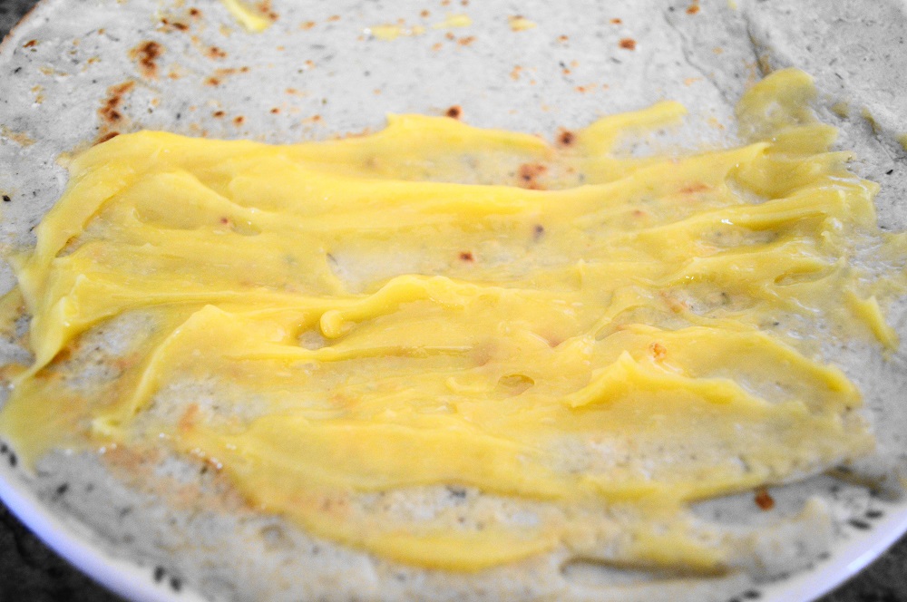 The batter yielded 4 crepes total. Once all of the crepes were cooked, I just filled them with the lemon curd. I spread two tablespoons on half of one, then folded it over. Then I spread more on half of the folded half before closing the crepe into a triangle. 