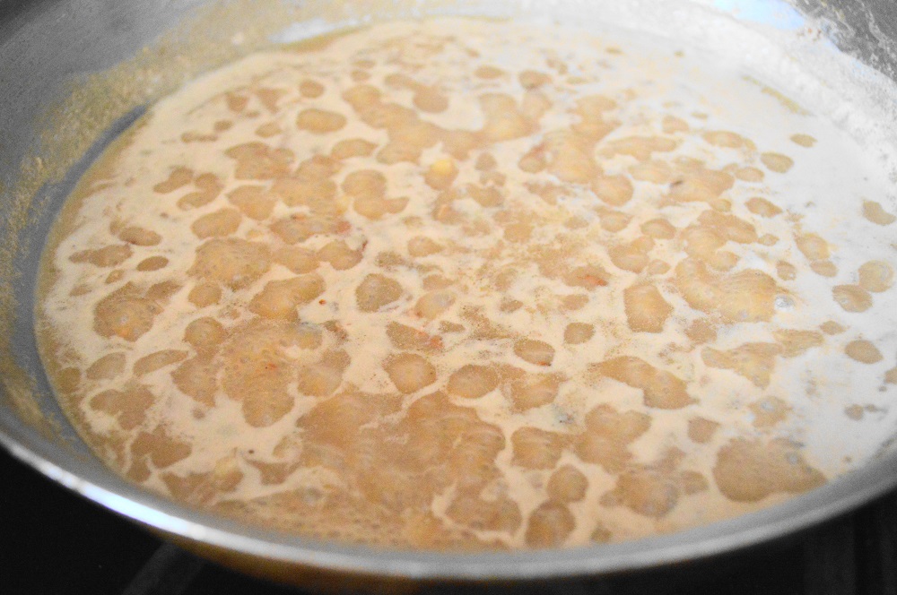 Once the pork chops were done, I removed them and started on the sauce. It was an incredible mixture of cognac, milk, garlic and salt. The cognac deglazed the pan and released all of the flavorful brown bits on the bottom of the pan. Once the sauce was reduced and thickened, I poured it through a fine mesh strainer. That ensured it was silky smooth. 