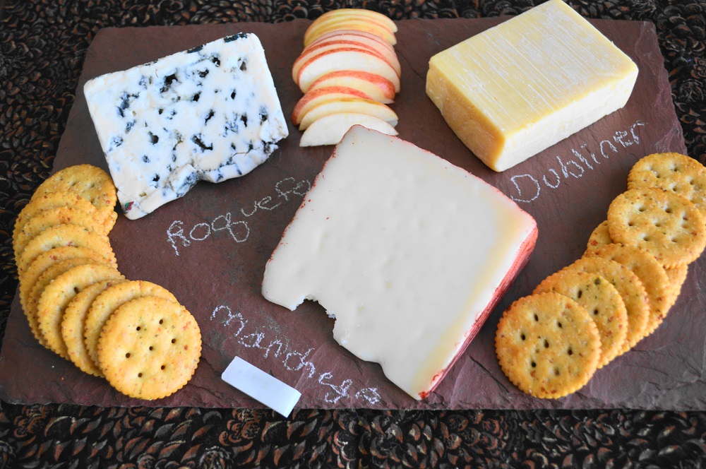 I am in love with the cheeseboard I got from uncommon goods. It's a heavy duty and durable slate with a gorgeous color to set off the cheeses. It came with chalk to label the cheeses so everyone could easily identify them too! I always like to do at least three different cheeses with crackers and some kind of fruit. This time I did a roquefort, manchego (my fave!) and because it's almost St. Patrick's Day, Dubliner cheese. Apple was perfect in this case because its sweetness mellowed the roquefort perfectly. 