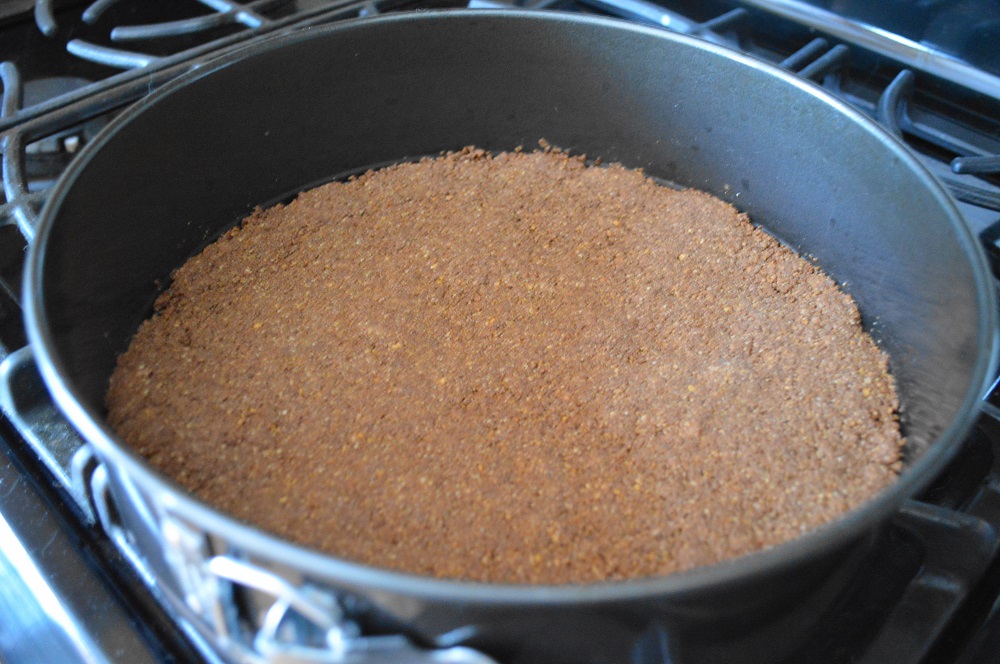The crust was a fantastic mixture of ground up peanuts, graham cracker crumbs, cocoa powder, sugar and butter. The butter made it like wet sand that I could firmly pack into the bottom of my springform pan. It was the perfect base for the chocolate peanut butter cheesecake!