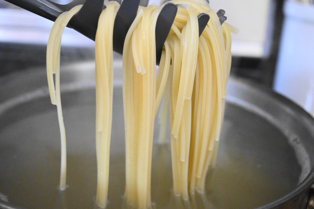 While the sauce cooked, I boiled a pound of linguine for just 5 minutes. I didn't want it to fully cook so that it could finish in the wine sauce. Spaghetti would have worked here too, I just happened to have linguine in the pantry. When the 5 minutes were up I just scooped that linguine right into the sauce.