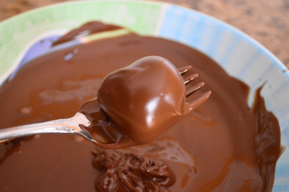 Once the centers were set, it was time to coat the tequila lime truffles in lovely milk chocolate that I just melted in the microwave. Milk chocolate gave the perfect counterpoint to the rich and dark bittersweet and semi-sweet chocolate in the middle. I rolled each of the centers in the melted chocolate just enough to barely coat them. Fishing them out with a fork allowed the excess to drip back into the bowl!