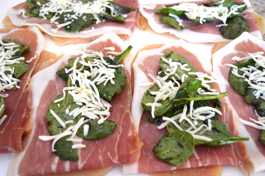 Then it was time to put together the chicken saltimbocca. I layered a paper thin slice of prosciutto onto each of my chicken breasts. The dressed spinach and shredded mozzarella cheese went on top. Then I just rolled each of them up tight like a jelly roll and secured them with toothpicks!