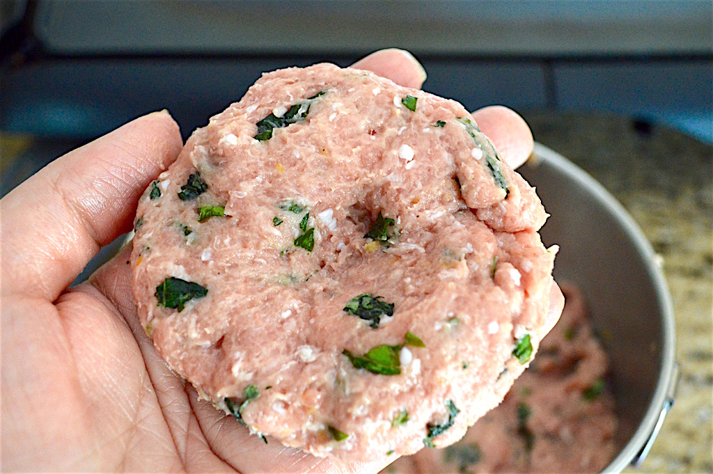 I formed 4 generously sized 1/4 pound basil lemon turkey burgers out of the mixture. Then I made an indentation in the middle of each of them. That way they would become even when they puffed up as they cooked! 