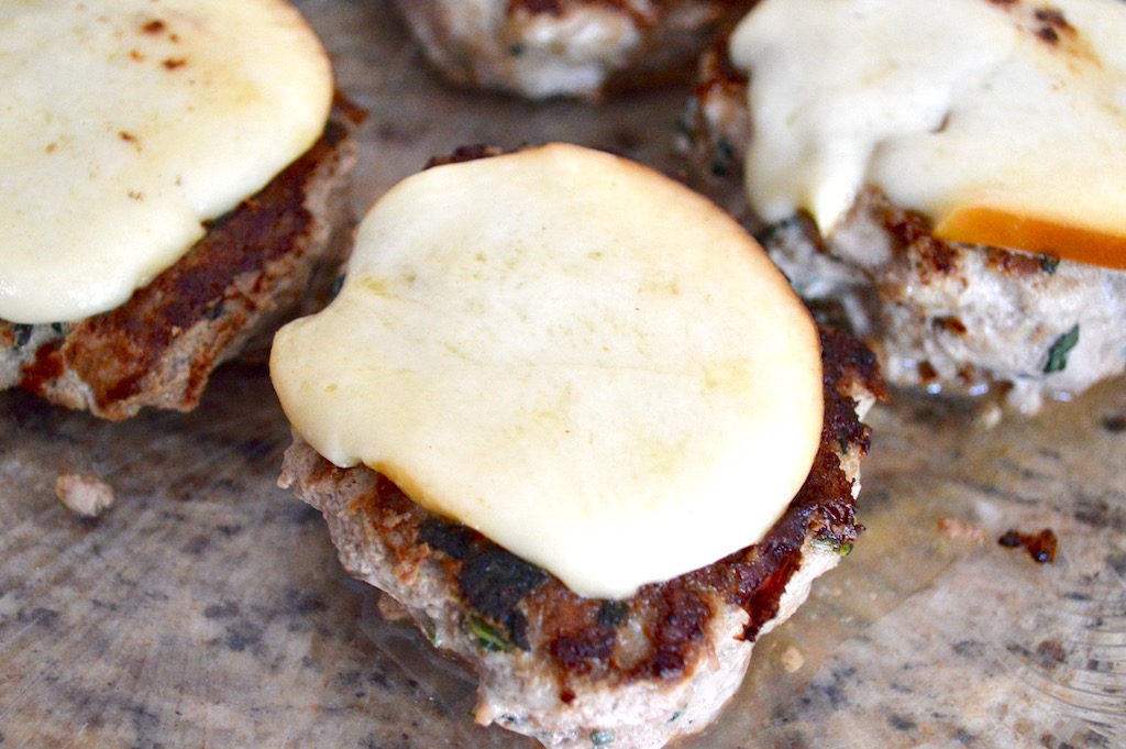 The trick to melting the mozzarella was to cover the burgers with my huge stainless steel bowl on the second side. It trapped the steam and just melded everything together gorgeously!