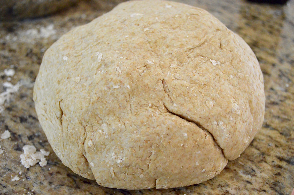 The dough for the whole wheat pita bread came together quickly. All I did was stir whole wheat flour, regular flour, active dry yeast, salt, olive oil and water together in a big bowl to turn it into a soft dough. It was important for the water to feel like bathwater to activate the yeast! Then I kneaded it for 10 minutes to make it super elastic and springy.