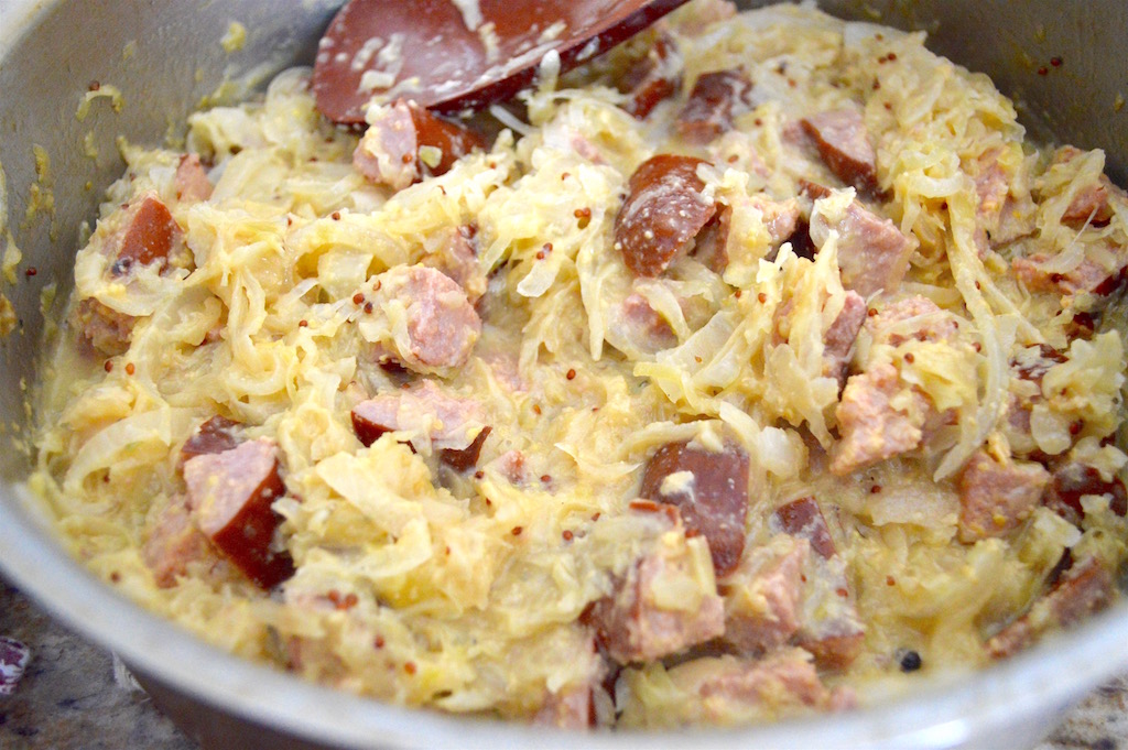 From there, putting the toppings together for the Polish style nachos was a cinch. It was such an incredible mixture full of onions, sauerkraut, the kielbasa and mustard. I simmered all of that in some beer for even more flavor. Once that was done simmering, I brought it all together with loads of extra sharp cheddar cheese!