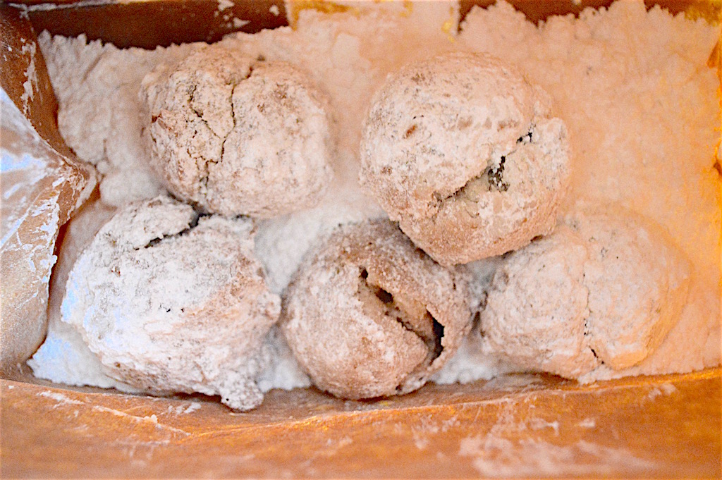 After I removed the lemon lavender zeppole from the oil, I let them drain on paper towel. Then I dropped them into a paper bag with lots of powdered sugar. I closed the bag and gave it a good shake to perfectly coat them! That's the way I saw it done on the boardwalk, so it seemed like the right thing to do. 