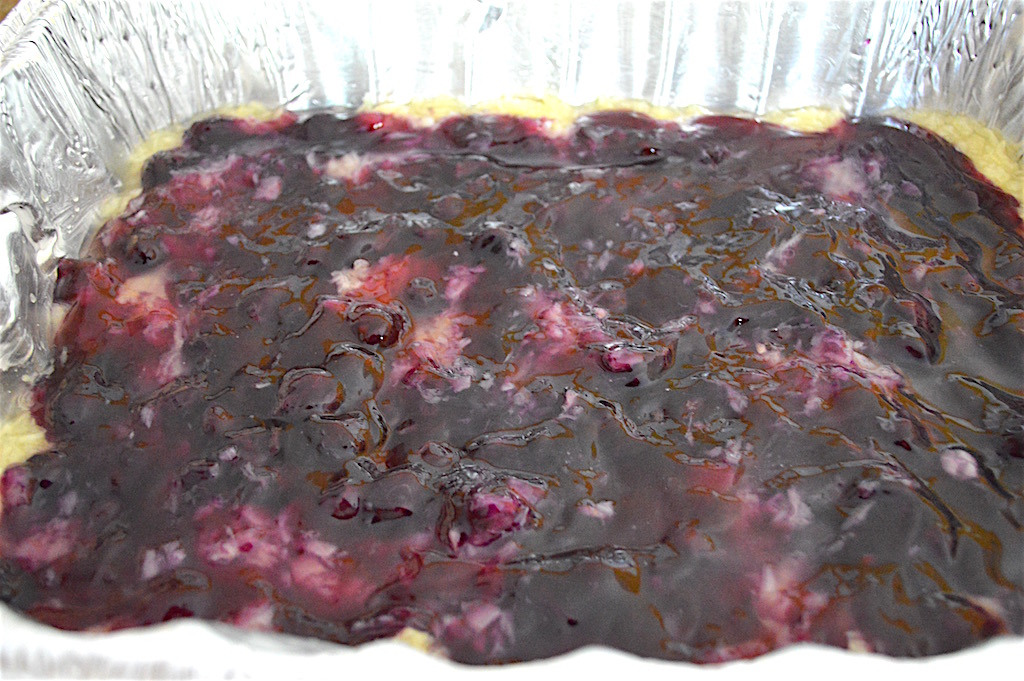 The beauty of this pineapple blueberry dump cake was that I didn't have to stir a darn thing. I layered a can of crushed pineapple in my pan first. Then I layered a can of blueberry pie filling on top of the pineapple. 