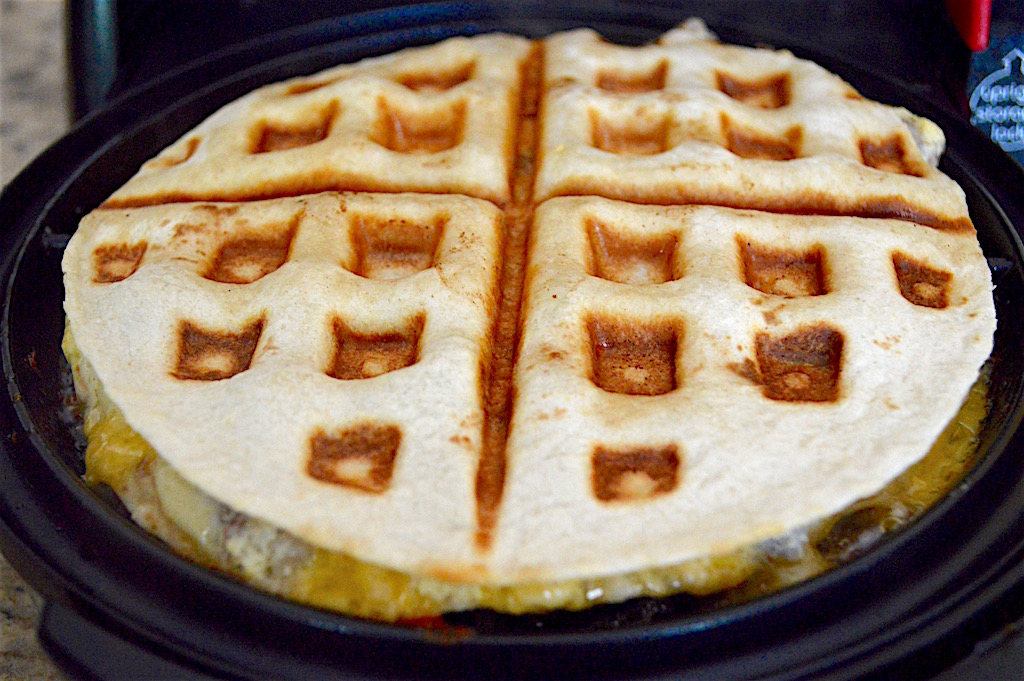 It took about 3 minutes for the breakfast quesadillas to cook perfectly in my beloved waffle iron. They were gooey, melty perfection! I made sure to clean and butter my waffle iron between cooking each quesadilla. That just ensured they came out as cleanly as possible. 