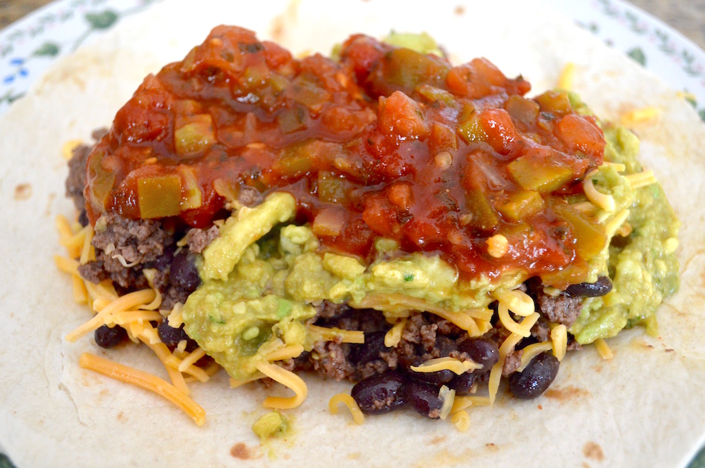 Big, tender flour tortillas were the perfect blanket to wrap up all of that gorgeous filling. I piled a little rice on the tortilla first, then the beef mixture, followed by cheddar cheese, guacamole and salsa. Oh my goodness it was a feast for the eyes already! Now, I am not a fan of sour cream. It's one of the few foods in this world that does nothing for me. By all means add it though if you want to! 