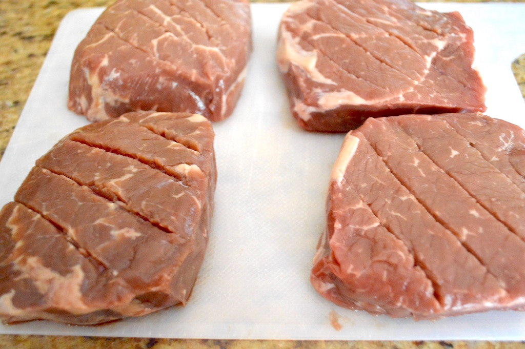 I found gorgeous sirloin steak for much cheaper than filet mignon. It was perfect for this dish! To prep it, I scored one side of it with shallow knife marks. That allowed the chimichurri sauce seep right into the steaks and make them so flavorful. 