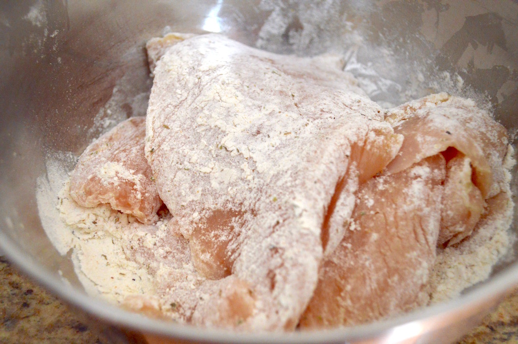 First, I made sure my chicken cutlets were pounded out nice and thin so that they would cook faster. Then for big flavor I dredged them in a flavorful mixture of flour, garlic powder, dried oregano, salt and pepper. 