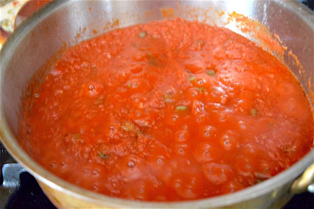 I made the yummy tomato caper sauce in the same pan that I browned the chicken cutlets. It was a fantastic mixture of crushed tomatoes, capers, chicken stock, garlic, basil and crushed red pepper. All of those things were right in my pantry except the basil, which is still hanging on in a pot in my window sill. The chicken cutlets gave the sauce a fantastic flavor base as well! 