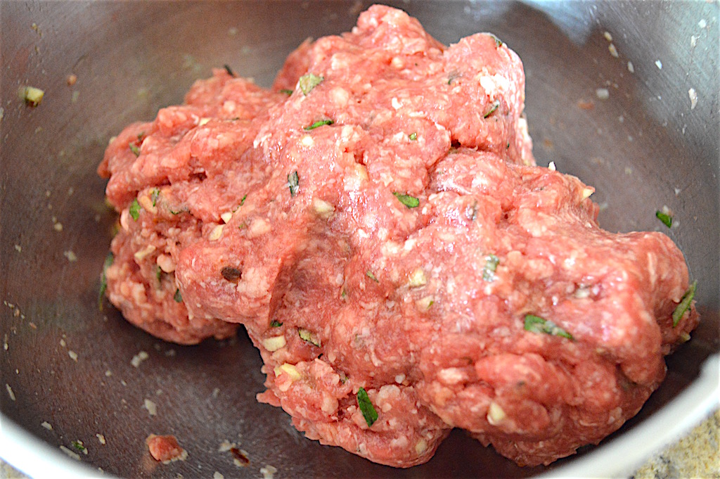 The meatloaf mixture was also really simple. It was just ground beef, parmesan cheese, herbs, seasoning and garlic held together with an egg. The key was to mix everything but the beef together first. That way I minimized how much I had to handle the ground beef when I mixed it in. That meant an extra tender and juicy prosciutto wrapped Italian meatloaf!