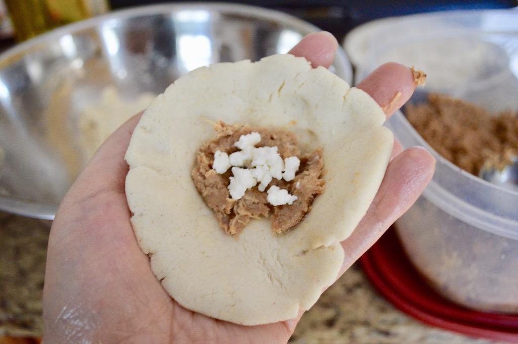 I used a 1/4 cup to measure perfect portions of the dough. Then I stuffed it with that glorious pork mixture and queso fresco. 