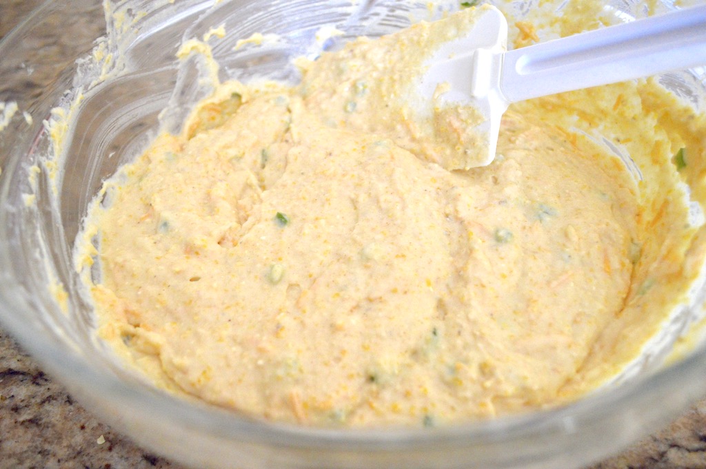 The batter for the cheddar jalapeno corn muffins came together quickly. I just whisked my wet ingredients right into my dry ingredients to make a thick, flavorful batter. Then I switched to a spatula to fold in lots of finely diced jalapeno and shredded cheddar cheese. 