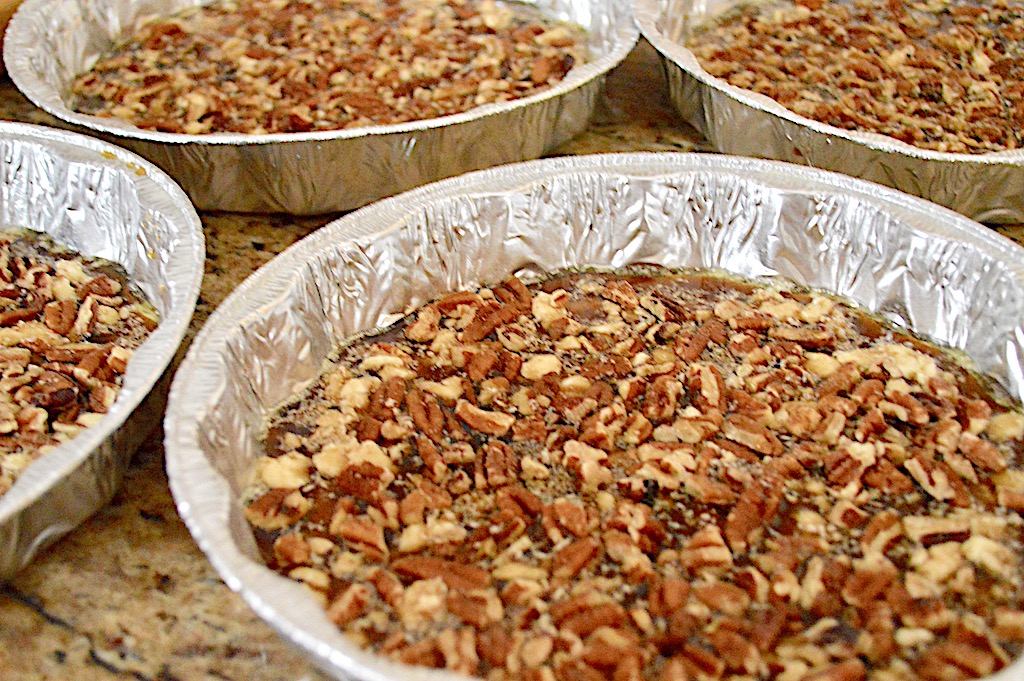 I divided that glaze among four well greased cake pans. Then I sprinkled a layer of pecans into each pan and pressed them into the glaze. 