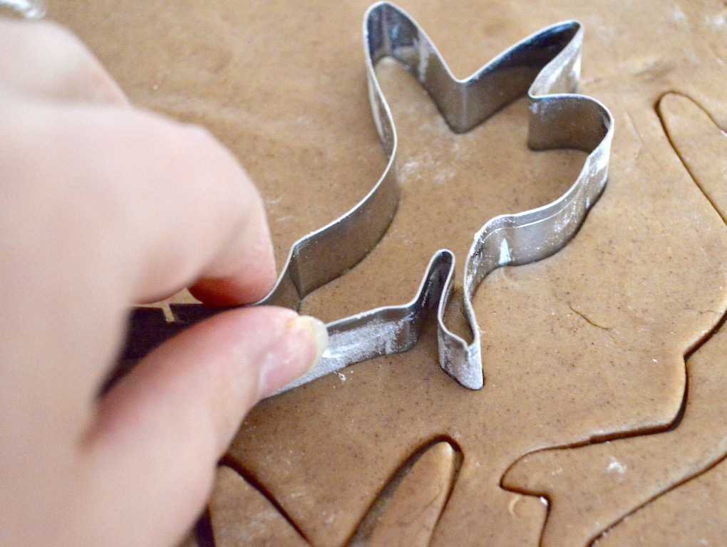 The chilled dough was still a little sticky, so I made sure to flour my work surface well. Then it was easy to roll it out and use my adorable fairy cutter! I laid them out on my lined cookie sheets to decorate them with loads of green colored sugar. 