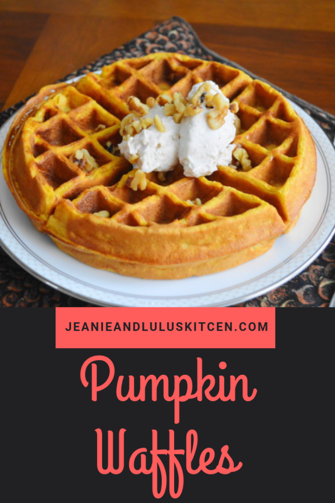 These are such fluffy and warmly spiced pumpkin waffles with a luscious whipped cream topping! Such a wonderful brunch. #breakfast #waffles #pumpkin #pumpkinwaffles #jeanieandluluskitchen