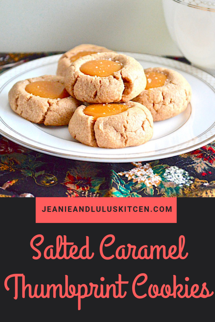 These salted caramel thumbprint cookies are such a fun and yummy part of any holiday baking with the deeply flavored cookie crust and luscious filling! #cookies #holidaybaking #saltedcaramel #saltedcaramelthumbprintcookies #jeanieandluluskitchen